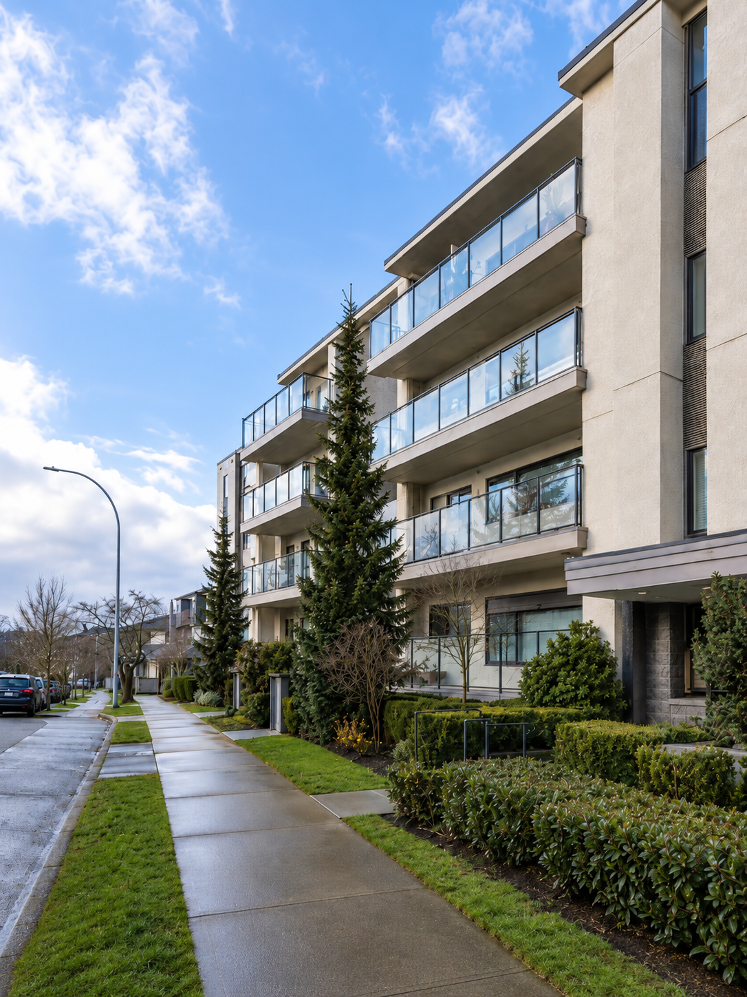 Low-rise multi-family building with glass balconies in Vancouver